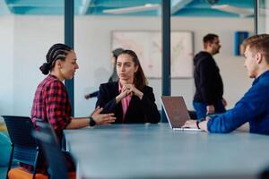 A team of successful programmers sits in a startup office, strategizing new business projects and solving existing challenges, showcasing innovation and collaboration in the tech industry photo