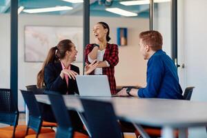 A team of successful programmers sits in a startup office, strategizing new business projects and solving existing challenges, showcasing innovation and collaboration in the tech industry photo