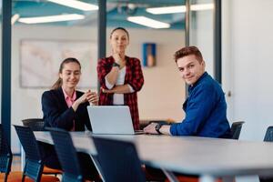 A team of successful programmers sits in a startup office, strategizing new business projects and solving existing challenges, showcasing innovation and collaboration in the tech industry photo