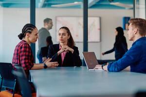 A team of successful programmers sits in a startup office, strategizing new business projects and solving existing challenges, showcasing innovation and collaboration in the tech industry photo