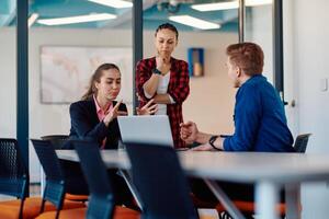 A team of successful programmers sits in a startup office, strategizing new business projects and solving existing challenges, showcasing innovation and collaboration in the tech industry photo