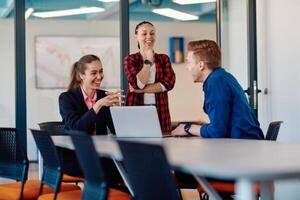 A team of successful programmers sits in a startup office, strategizing new business projects and solving existing challenges, showcasing innovation and collaboration in the tech industry photo