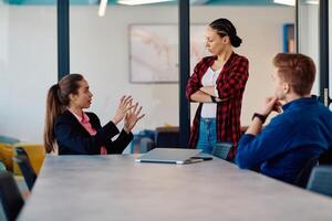 A team of successful programmers sits in a startup office, strategizing new business projects and solving existing challenges, showcasing innovation and collaboration in the tech industry photo