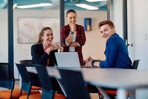 A team of successful programmers sits in a startup office, strategizing new business projects and solving existing challenges, showcasing innovation and collaboration in the tech industry photo