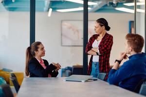 A team of successful programmers sits in a startup office, strategizing new business projects and solving existing challenges, showcasing innovation and collaboration in the tech industry photo