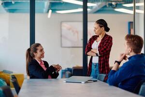 A team of successful programmers sits in a startup office, strategizing new business projects and solving existing challenges, showcasing innovation and collaboration in the tech industry photo
