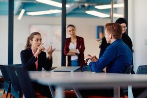A team of successful programmers sits in a startup office, strategizing new business projects and solving existing challenges, showcasing innovation and collaboration in the tech industry photo
