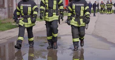 The reflection in water reveals a team of specially equipped firefighters coordinating and embarking on a high-risk, life-saving mission to rescue people in distress, showcasing their unwavering video