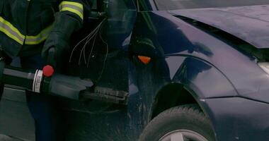 A skilled team of firefighters employs specialized tools and quick reactions to successfully extricate a person trapped in a car, showcasing their heroism and precision in a high-stakes rescue video