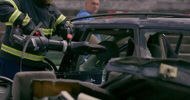 A skilled team of firefighters employs specialized tools and quick reactions to successfully extricate a person trapped in a car, showcasing their heroism and precision in a high-stakes rescue video