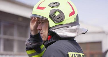 A close-up shot focuses on a firefighter's face as they discuss an evacuation plan, exemplifying their professionalism and dedication in ensuring the safety of people in a fire hazard area video