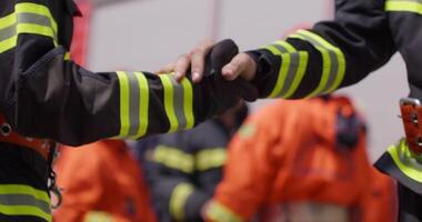 A team of firefighters comes together to celebrate and share their joy and relief after a successful operation, demonstrating the strong bond and camaraderie among these heroic individuals video