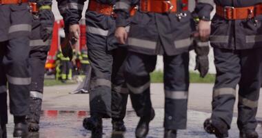 A specialized firefighting unit equipped with special attire and advanced equipment embarks on a hazardous fire suppression mission, showcasing their professionalism and readiness to combat fires in video