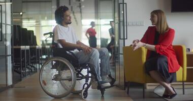 African American businessman in a wheelchair engages in a professional discussion with his colleague, addressing various business challenges and exploring solutions in an inclusive and diverse modern video