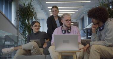 A diverse group of colleagues exchange business experiences, engage in collaborative problem-solving, and work together in a relaxed, modern office interior, demonstrating the value of teamwork and video