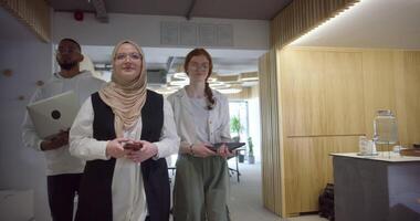 A diverse group of colleagues collaboratively and efficiently tackles various business tasks in a modern office, exemplifying teamwork, productivity, and a dynamic corporate environment. video
