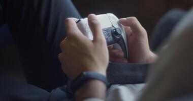 A business company's director takes a break from work in a modern office and indulges in gaming, using a joystick to play games on a TV, combining leisure and relaxation with a dash of office video