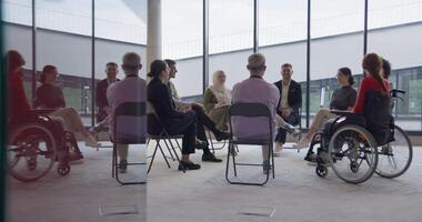 A diverse group of young business entrepreneurs gathered in a circle for a meeting, discussing corporate challenges and innovative solutions within the modern confines of a large corporation video