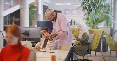 A diverse group of colleagues collaborates in modern offices, showcasing their collective problem-solving skills and innovative approach to address a variety of business challenges. video