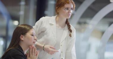 Modern businesswomens using hand gestures to explain business tasks to their colleagues, showcasing effective communication, collaboration, and problem-solving in a contemporary corporate setting video