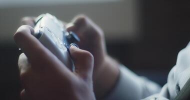 A business company's director takes a break from work in a modern office and indulges in gaming, using a joystick to play games on a TV, combining leisure and relaxation with a dash of office video