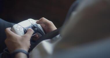 A business company's director takes a break from work in a modern office and indulges in gaming, using a joystick to play games on a TV, combining leisure and relaxation with a dash of office video