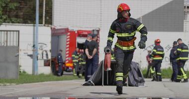 A team of firefighters swiftly readies water hoses, demonstrating their urgent response to prepare for a dangerous fire suppression mission, highlighting their commitment to firefighting and safety. video