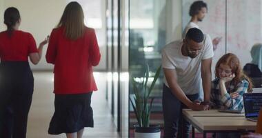 A diverse group of business colleagues engage in discussions about various business challenges, surrounded by their coworkers in a modern startup office, showcasing teamwork, innovation, and problem video