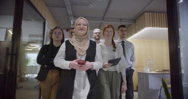 A diverse group of colleagues collaboratively and efficiently tackles various business tasks in a modern office, exemplifying teamwork, productivity, and a dynamic corporate environment. video