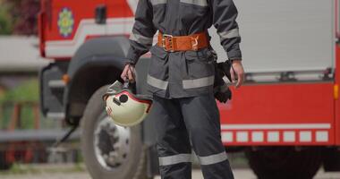 A special firefighter stands beside a firetruck, poised and ready for a high-risk rescue mission in dangerous fire scenarios, exemplifying unwavering dedication to saving lives in emergency video