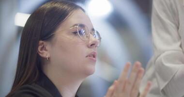 Modern businesswomens using hand gestures to explain business tasks to their colleagues, showcasing effective communication, collaboration, and problem-solving in a contemporary corporate setting video