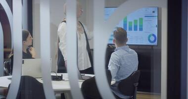 A diverse group of colleagues collaboratively and efficiently tackles various business tasks in a modern office, exemplifying teamwork, productivity, and a dynamic corporate environment. video