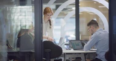 A diverse group of colleagues collaboratively and efficiently tackles various business tasks in a modern office, exemplifying teamwork, productivity, and a dynamic corporate environment. video