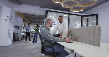 A diverse group of colleagues collaboratively and efficiently tackles various business tasks in a modern office, exemplifying teamwork, productivity, and a dynamic corporate environment. video