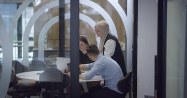 A diverse group of colleagues collaboratively and efficiently tackles various business tasks in a modern office, exemplifying teamwork, productivity, and a dynamic corporate environment. video
