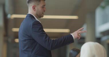 A diverse group of entrepreneurs engages in a dynamic business meeting within a modern office, showcasing their collaborative spirit and innovative approach to business development video