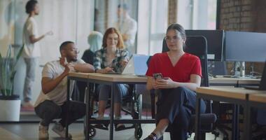 A diverse group of colleagues collaborates using laptops, mobiles, and tablets to tackle business challenges and enhance productivity through teamwork and innovative technology. video