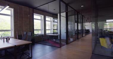 Modern startup centers composed of glass offices within a contemporary corporate environment, highlighting the sleek, innovative, and minimalist design aesthetics of a cutting-edge workspace video