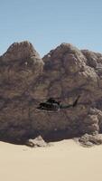 A helicopter flying over a mountain with a rock formation in the background video