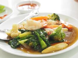 Thai style crab omelet, egg yellow food on white plate photo
