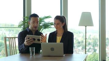 Businesswoman Talking to Businessman Using Laptop Computer Screen video