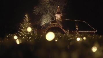Cozy Christmas Lights on Chapel and Tree at Night, Creating a Warm and Festive Atmosphere video