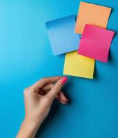 Colorful Paper Stickers with Space for Text and Hand Holding Sticky Notes photo
