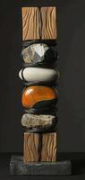 An artistic sculpture is created by combining stones and wooden blocks to display a mix of natural elements and craftsmanship, reflecting a modern art style with a variety of textures. Phone wallpaper photo