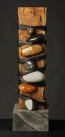 An artistic sculpture is created by combining stones and wooden blocks to display a mix of natural elements and craftsmanship, reflecting a modern art style with a variety of textures. Phone wallpaper photo