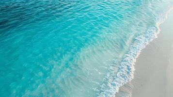 Stunning aerial view captures the beauty of turquoise waves gently crashing on a white sandy beach, offering a serene and calming atmosphere. Ideal for relaxing and natureinspired themes photo