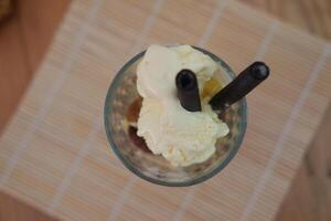 Glass filled with ice cream and wafer photo