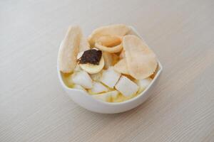 lontong sayur- Compressed rice cake served with curry coconut milk sauce and vegetables and boiled egg photo