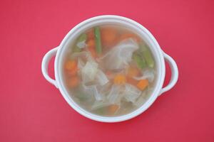 A bowl of vegetable soup on a table photo