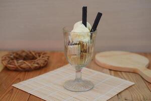 Glass filled with ice cream and wafer photo